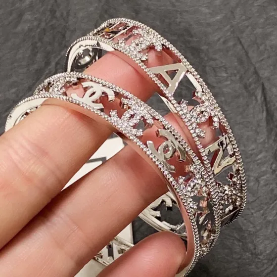 Chanel CC Logo Cutout Crystal Cuff bracelet silver-toned metal with clear crystal accents 17cm inner circumference