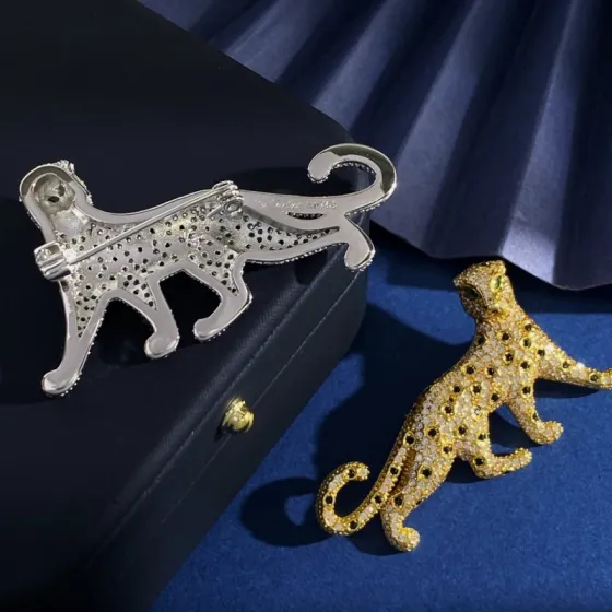 Cartier Panthere de Cartier brooch Silver-toned metal with clear pave stones black spot accents green stone eyes Gold-toned metal with clear pave stones black spot accents green stone eyes Rose gold-toned metal with clear pave stones black spot accents green stone eyes 4 5cm length