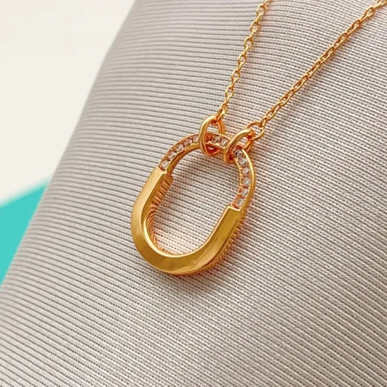 Tiffany Co Tiffany Lock necklace 18k yellow gold with clear diamond accents 18 inches