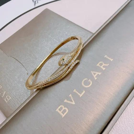 Bvlgari Serpenti bracelet Yellow gold with clear pave diamonds and green gemstone eyes 17cm