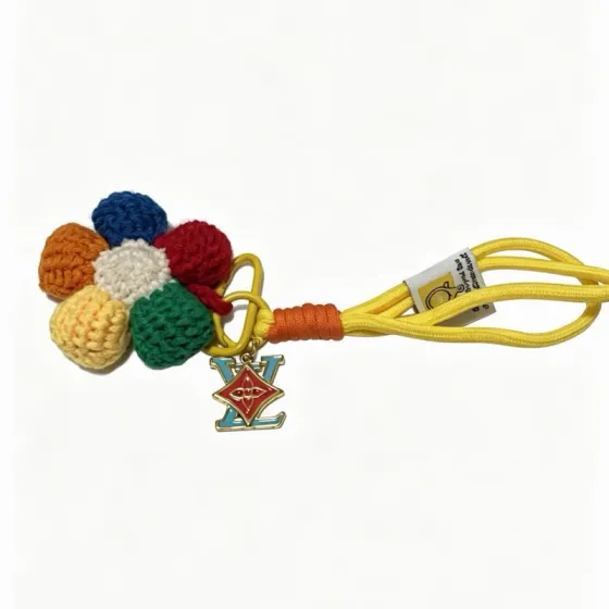 Louis Vuitton Anger Forest Crochet Flower Keychain Charm pendant Gold-tone metal with red and light blue enamel multicolor crocheted yarn navy red orange cream pale yellow green yellow nylon cord with orange cord wrap 18cm strap length