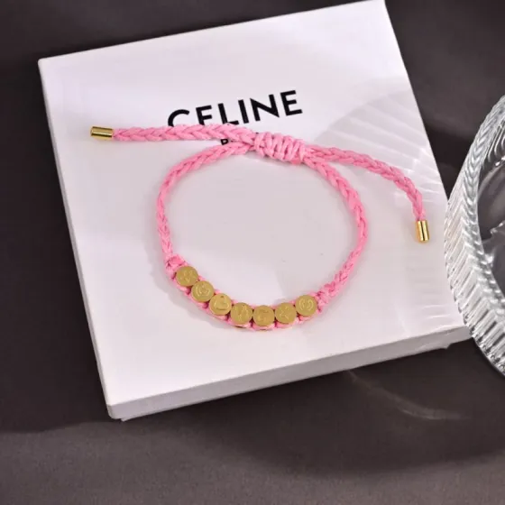 Celine PLAGE bracelet Pink braided cord with gold-tone metal charms and end caps Adjustable sliding knot fits 15-20cm wrist