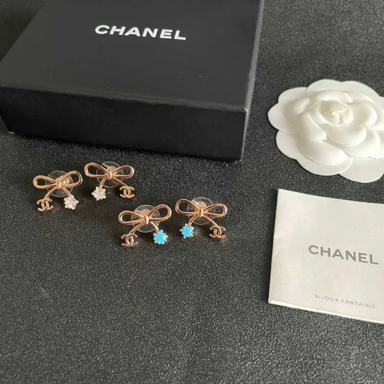 Chanel CC Bow Star Charm Stud Earrings earrings Rose gold light gold tone metal with clear crystal or turquoise blue star accents One Size standard stud earring dimensions approx 1 5cm width