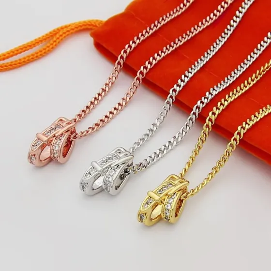 Hermes Buckled Diamond Pendant necklace Available in rose gold silver and yellow gold metal tones with clear diamond accents 40cm
