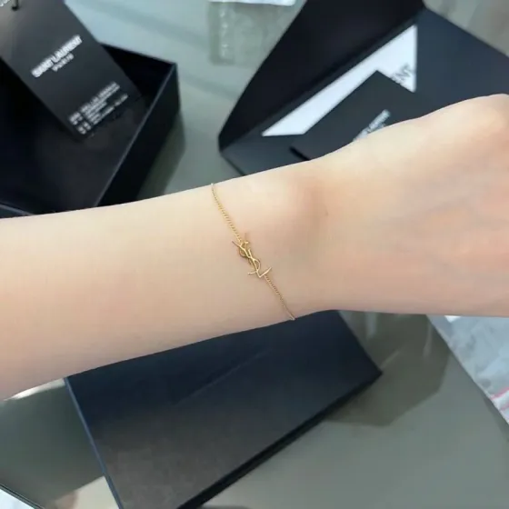 Saint Laurent Cassandre YSL Logo bracelet gold-tone metal no gemstones 16cm with 3cm extender