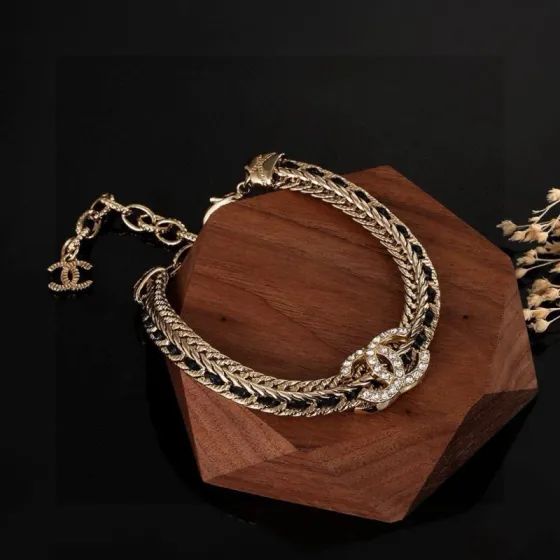Chanel CC Crystal Woven Chain Bracelet bracelet Light gold tone metal with black woven leather inlay and clear crystal accents 18cm with 5cm extension