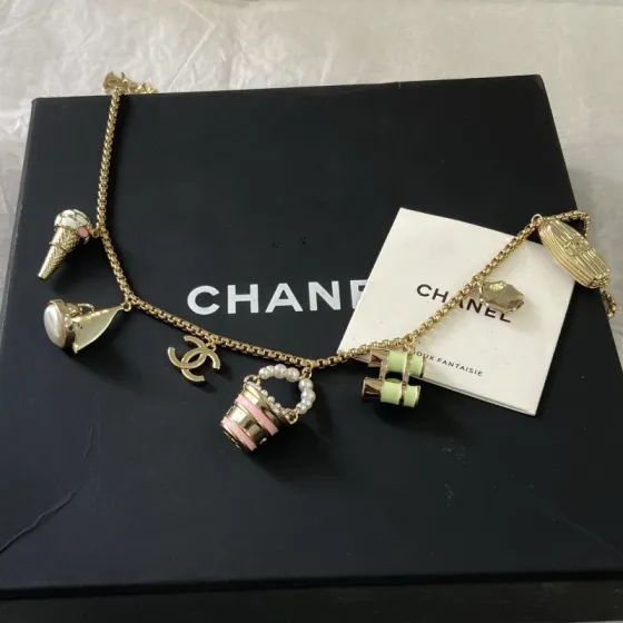 Chanel CC Logo Beach Vacation Charms Collection necklace Gold-tone metal with white faux pearls pink enamel light green enamel clear crystal accents and cream pearl cabochon 42cm with 5cm extender chain