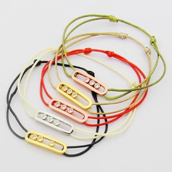Messika Move Uno bracelet available variants 18K white gold with khaki green cord 18K white gold with black cord 18K rose gold with off-white cord 18K yellow gold with beige cord all set with clear round brilliant diamonds adjustable sliding knot cord fits 15-20cm wrist