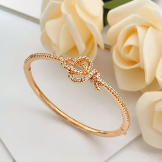 Tiffany Co Knot bracelet Rose gold metal with clear diamond accent stones 17cm inner circumference