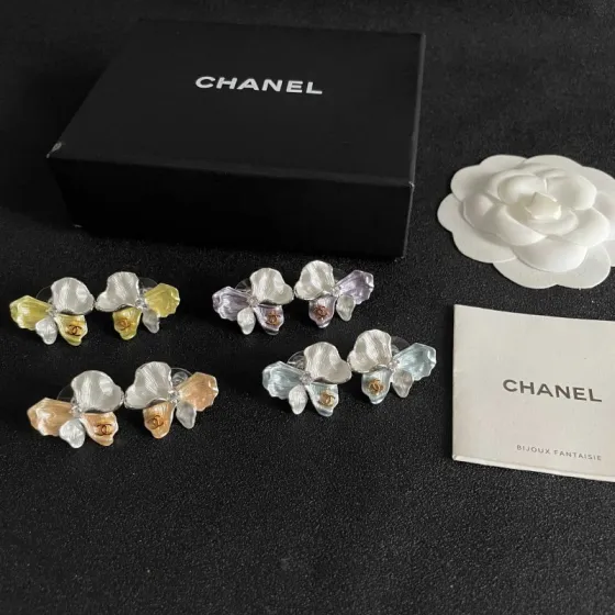 Chanel CC Logo Iridescent Flower Stud Earrings earrings Silver-toned metal with iridescent pearlescent white pale blue pale yellow pale purple or pale peach enamel petals gold-tone interlocking CC logo clear crystal accent One Size 2cm width per earring