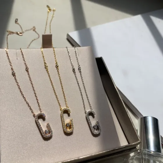 Messika Gigi Hadid Move Addiction Safety Pin Pendant Necklace necklace Available in 18k yellow gold 18k rose gold 18k white gold with pave set clear diamonds and a central moving diamond 42cm adjustable chain