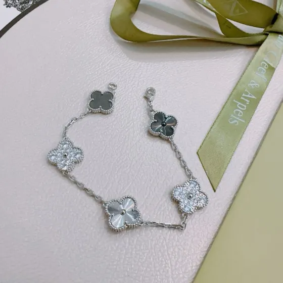 Van Cleef Arpels Alhambra bracelet silver-toned metal with clear diamond accents dark gray stone and silver guilloche clover motifs 19cm