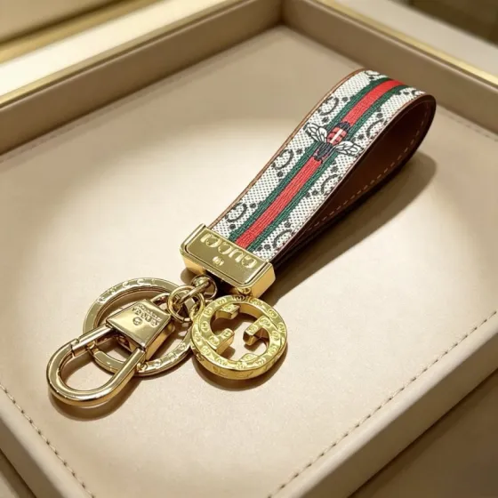 Gucci Anger Forest Bee Web GG Keychain pendant Gold-tone metal beige GG Supreme canvas with red and green web stripes brown leather trim multicolor bee embroidery 10cm strap length
