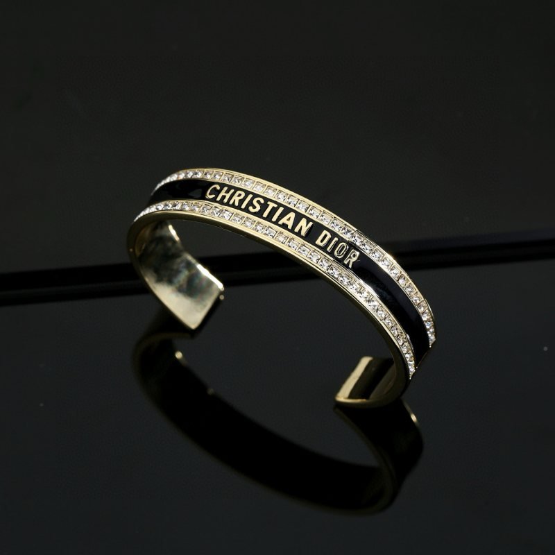 Dior Christian Dior CD Signature Enamel Crystal Cuff bracelet Gold-tone metal with clear crystals available in black enamel or white enamel variants One Size open cuff standard 17cm inner circumference
