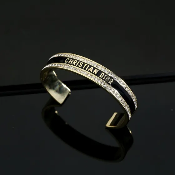 Dior Christian Dior CD Signature Enamel Crystal Cuff bracelet Gold-tone metal with clear crystals available in black enamel or white enamel variants One Size open cuff standard 17cm inner circumference