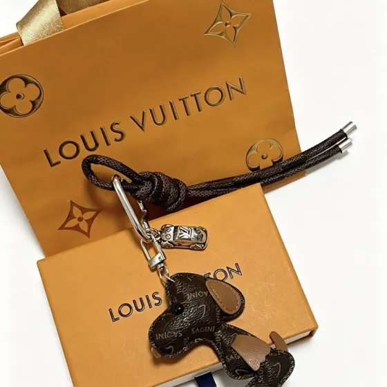 Louis Vuitton Anger Forest Dog Charm Keychain pendant Silver-tone metal dark brown monogram coated canvas tan leather accents black braided cord black enamel eye detail 18cm braided lanyard