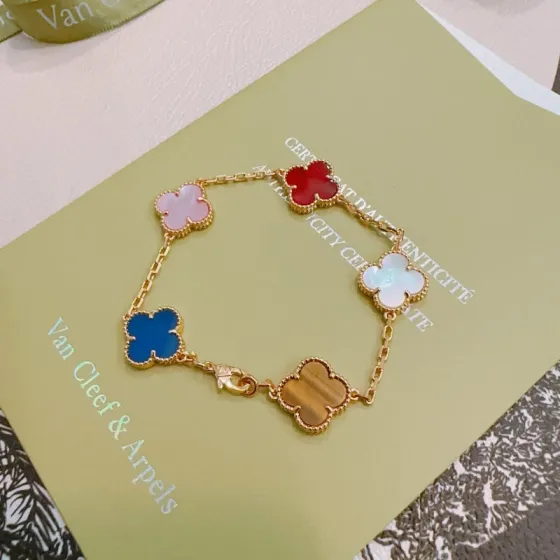 Van Cleef Arpels Alhambra bracelet Gold-toned metal with pink mother-of-pearl red carnelian white mother-of-pearl blue agate and brown tiger s eye clover motifs 17cm