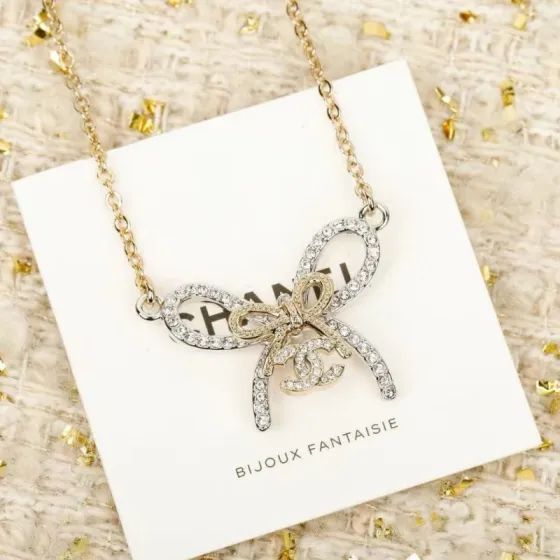 Chanel CC Bow Crystal Pendant Necklace necklace Two-tone gold and silver toned metal with clear crystal accents 42cm with 5cm extender