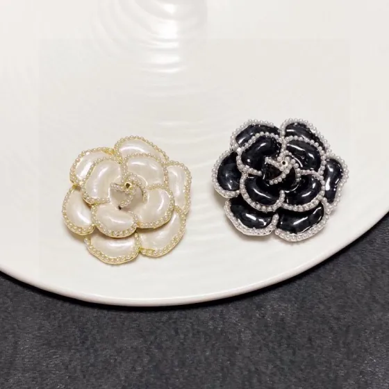 Chanel Camellia brooch Gold-tone metal with off-white enamel and faux pearl beading silver-tone metal with black enamel and faux pearl beading 4cm diameter