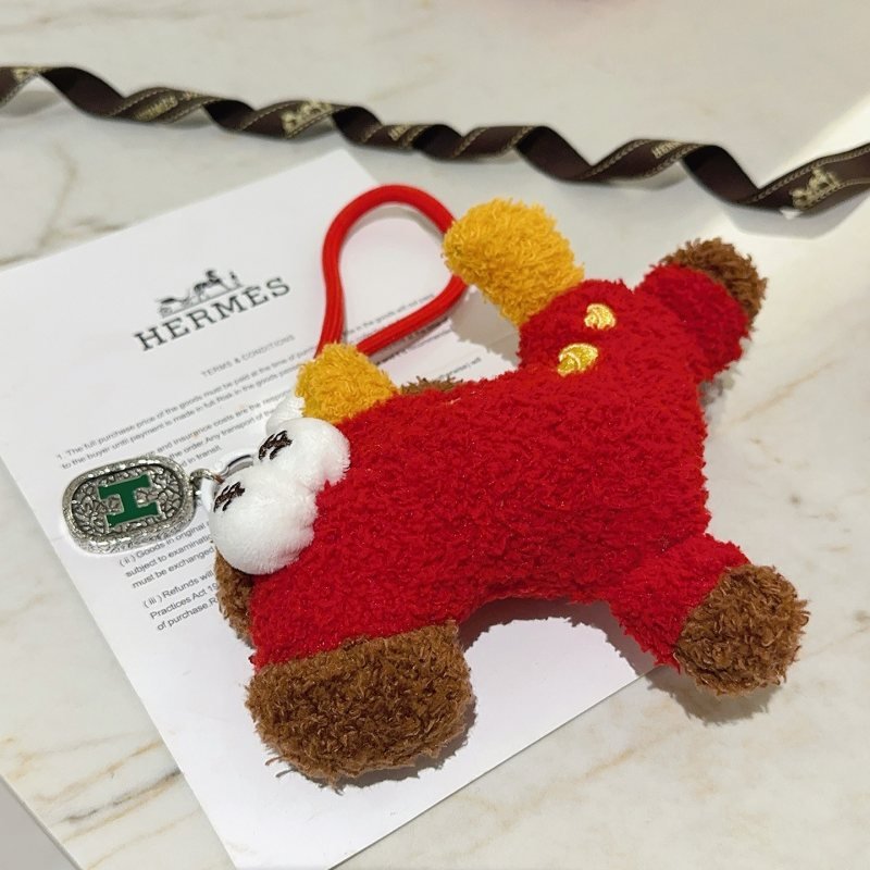 Hermes Plush Horse Charm Keychain pendant Red plush body yellow plush ears brown plush hooves white plush eyes with black embroidery gold embroidered details silver-tone metal tag with green enamel H logo red elastic strap 12cm charm length with 8cm