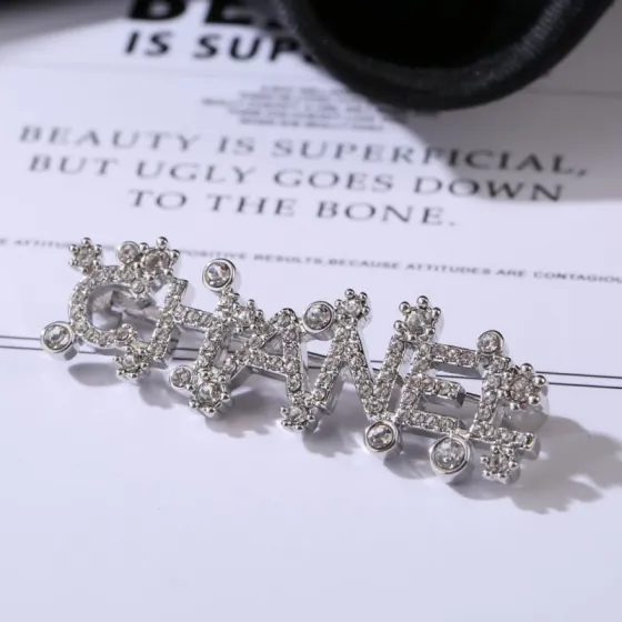 Chanel Crystal Embellished CHANEL Letter Brooch brooch silver tone metal with clear crystal accents 4 5cm width