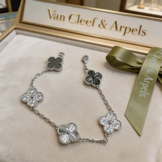 Van Cleef Arpels Alhambra bracelet Silver-toned metal with clear diamond-like stones dark gray stone silver guilloche metal and dark gray clover inlays 19cm