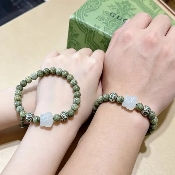Gucci Anger Forest bracelet silver-toned metal with green enamel accents green serpentine beads white jade carved charm 18cm