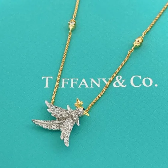 Tiffany Co Bird on a Point necklace Two-tone yellow gold and platinum-plated metal clear pave diamonds blue sapphire eye 18 inches