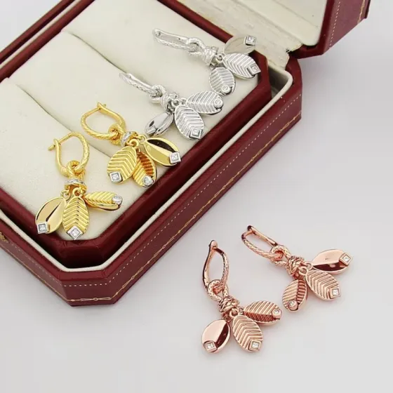 Cartier Grain de Cafe earrings Available in 18k yellow gold with white gold accents and clear diamonds 18k white gold with clear diamonds and 18k rose gold with clear diamonds One Size