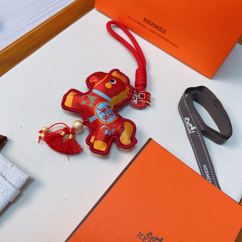 Hermes Year of the Horse Lucky Tassel Charm pendant Red fabric with gold blue green decorative details red cord strap gold-tone metal hardware red tassels 12cm total length