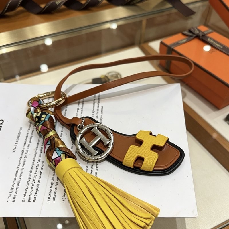 Hermes Oran Sandal Tassel Key Charm pendant Gold-tone and silver-tone metal yellow and brown leather multicolor silk black trim 18cm lanyard length