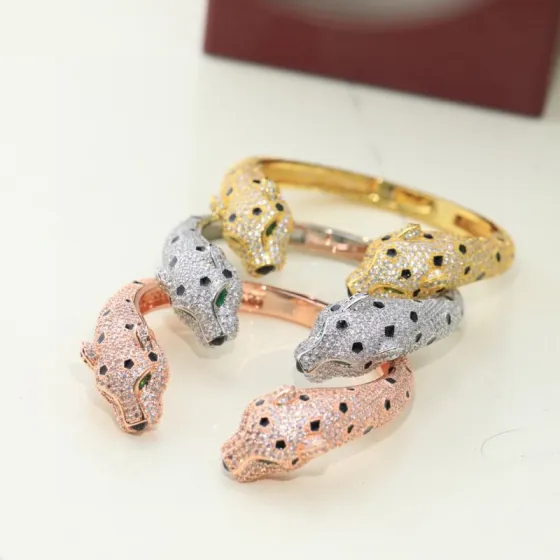 Cartier Panthere de Cartier bracelet Available in 18K yellow gold 18K rose gold and 18K white gold all fully paved with colorless diamonds accented with black onyx spots emerald eyes and black onyx nose details 17cm inner circumference