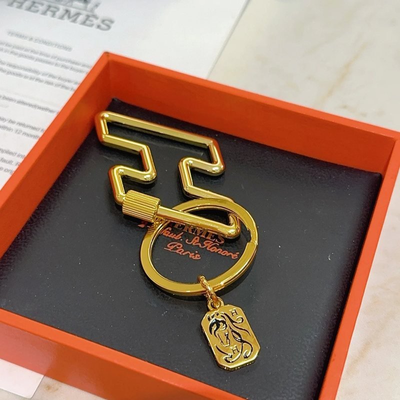 Hermes Cheval Horse Tag Zigzag Key Holder pendant gold tone metal with black enamel detailing 8cm total length