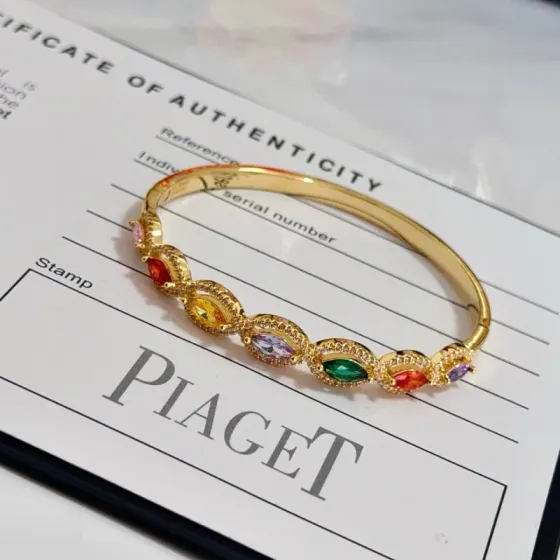 Piaget Rose des Vents Multicolor Gemstone Bangle bracelet Yellow gold metal with pink red orange yellow purple green marquise-cut gemstones accented by clear pave stones 17cm inner circumference