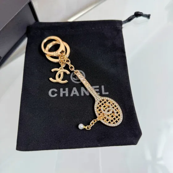 Chanel CC Tennis Racket Bag Charm Keychain pendant Gold-tone metal with clear crystals and white faux pearl Silver-tone metal with clear crystals and white faux pearl 10cm total length
