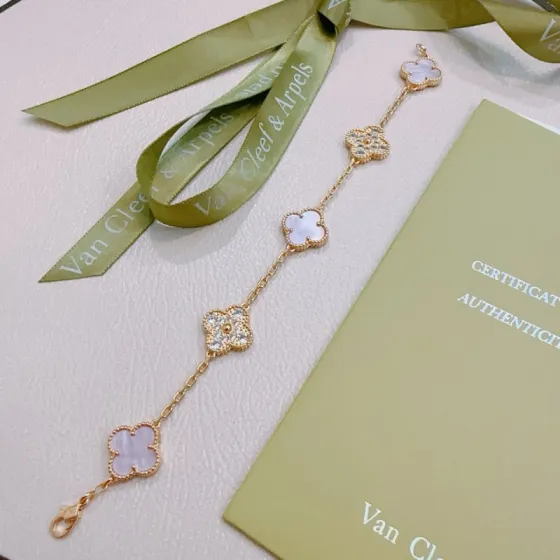 Van Cleef Arpels Alhambra bracelet gold-tone metal with iridescent white mother-of-pearl and clear diamond accents 18cm