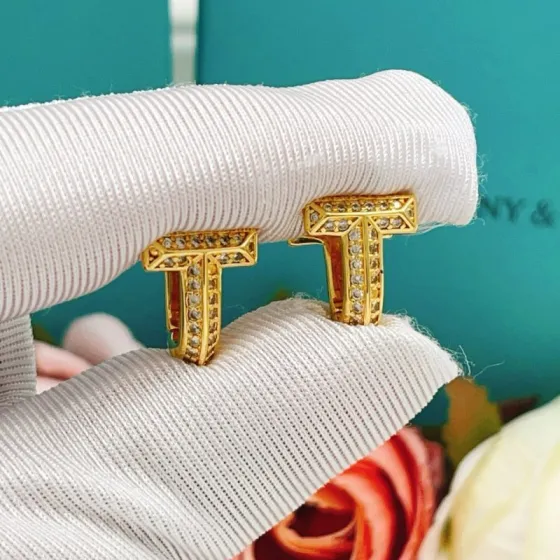 Tiffany Co Tiffany T earrings yellow gold with clear diamond accents 10mm hoop diameter