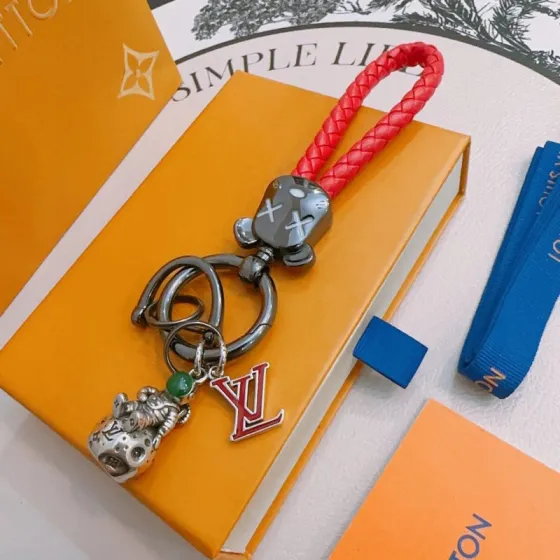 Louis Vuitton Anger Forest Astronaut Bear Keychain pendant Gunmetal gray metal red braided leather silver-toned charm green stone accent red enamel LV logo 12cm total length