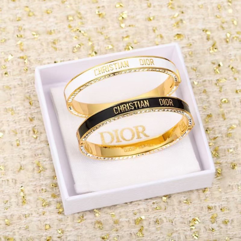 Dior Christian Dior Code Bangle bracelet Gold-tone metal with clear crystal accents available in black enamel and white enamel variants 17cm inner circumference