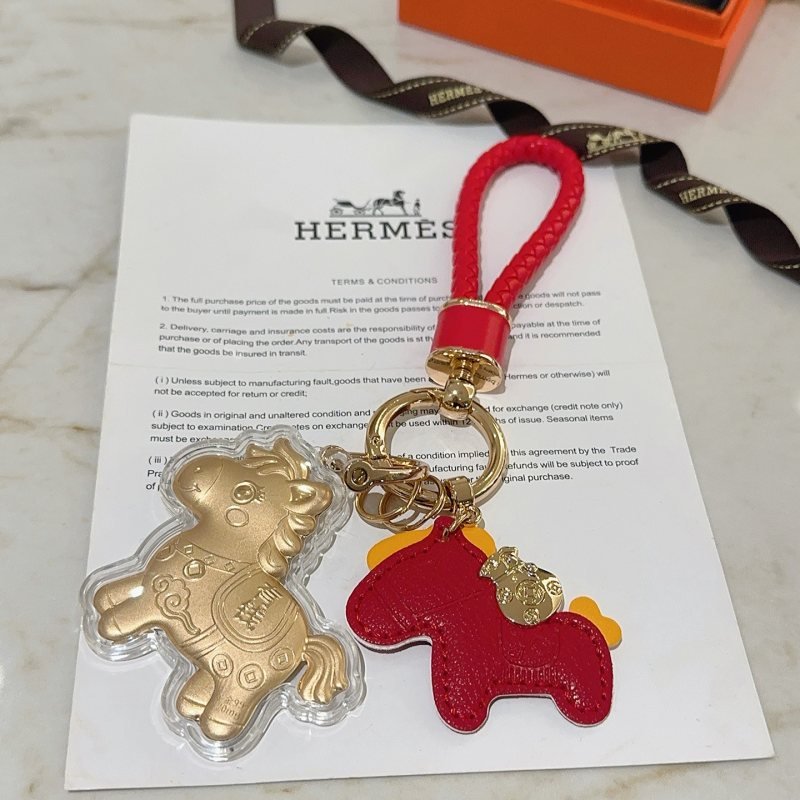 Hermes Lucky Horse Charm Keychain pendant Red braided leather gold-tone metal red leather horse charm gold horse charm with clear protective casing yellow accent details 10cm total length