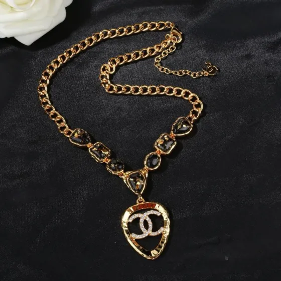 Chanel CC Logo Heart Pendant Necklace necklace Gold-tone metal with black gold-flecked resin stones and clear crystal accents 42cm with 5cm extender chain