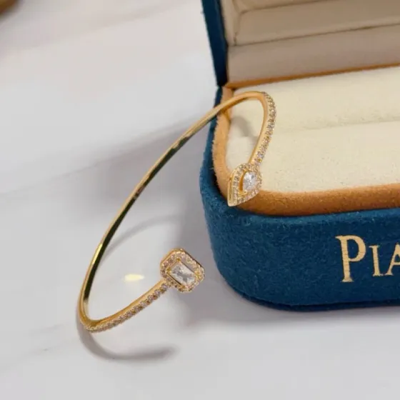 Piaget Treasures Open Cuff Bangle bracelet 18k yellow gold with clear diamond accent stones 17cm inner circumference