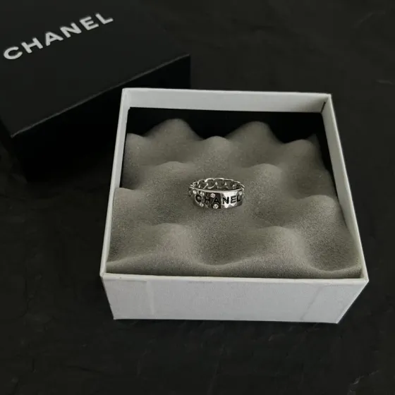 Chanel Logo Chain Crystal Ring ring Silver-toned metal with clear crystal accents and black enamel lettering US 7
