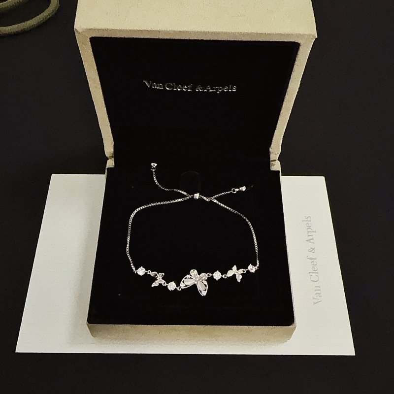 Van Cleef Arpels Butterfly Motif Diamond Inlaid Adjustable Bracelet bracelet Silver-toned white gold metal with clear diamond accents and mother-of-pearl butterfly inlays Adjustable sliding closure fits 15-20cm wrist