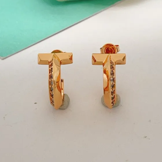 Tiffany T1 earrings rose gold metal with clear diamond accents 10mm hoop diameter