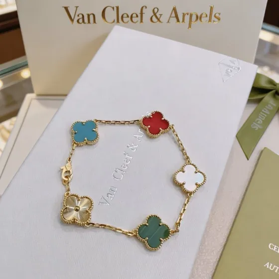 Van Cleef Arpels Alhambra bracelet Yellow gold metal with blue turquoise red carnelian white mother-of-pearl green malachite and gold guilloche clover motifs 17cm