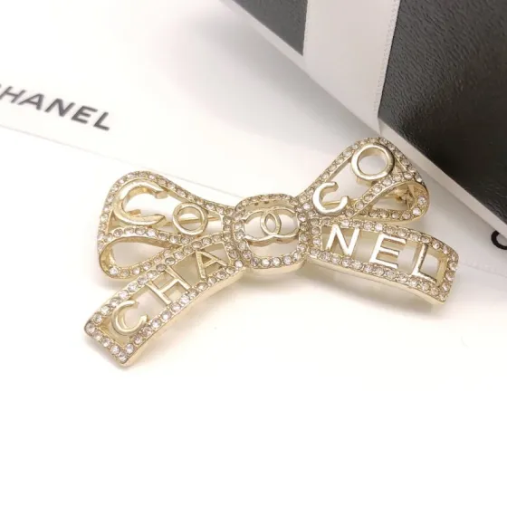 Chanel Coco Chanel Bow Logo Crystal Brooch brooch light gold tone metal with clear crystal accents 4 5cm width