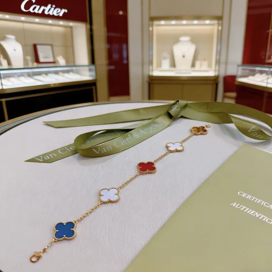Van Cleef Arpels Alhambra bracelet Yellow gold metal with blue agate white mother-of-pearl red carnelian and tiger s eye stone clover motifs 19cm