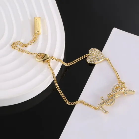 Saint Laurent YSL Monogram Crystal Heart Charm Bracelet bracelet gold-tone metal with clear crystal accents 19cm with 3cm extender