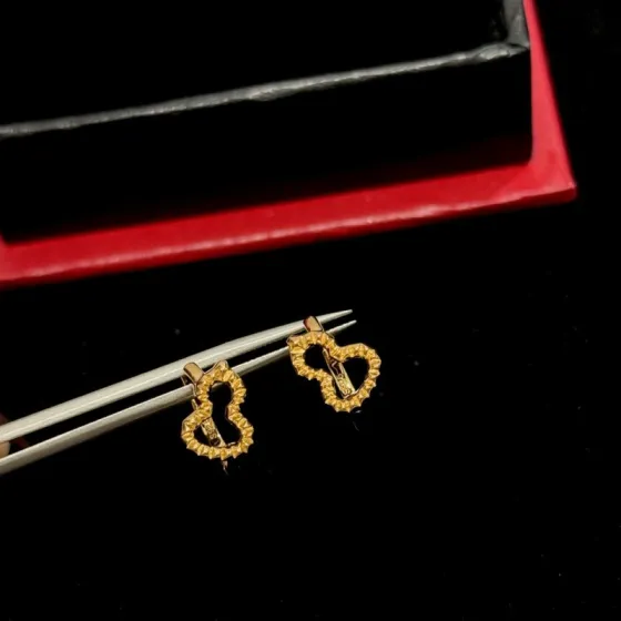 Qeelin Wulu earrings gold tone metal with faceted detailing no gemstones 10mm hoop diameter